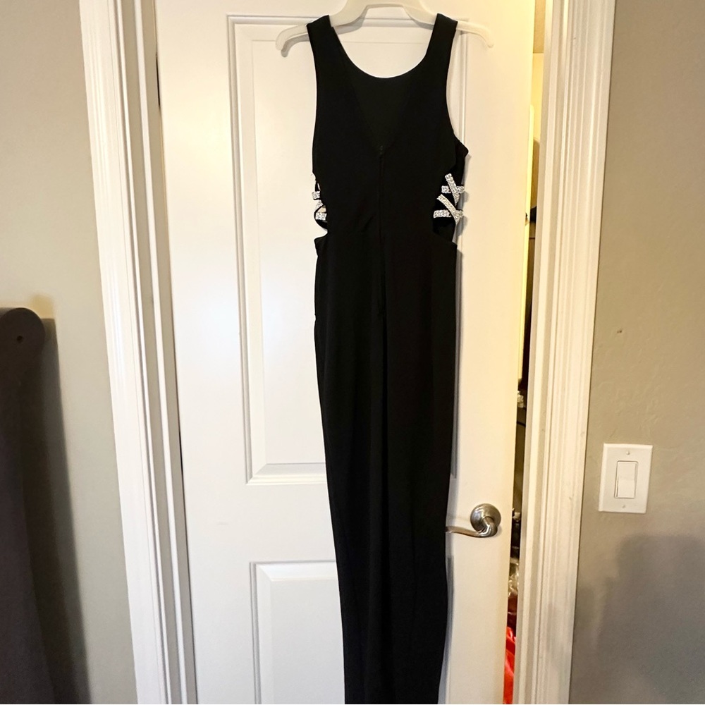 Black maxi modest fitted dress with silver detailing on the sides.